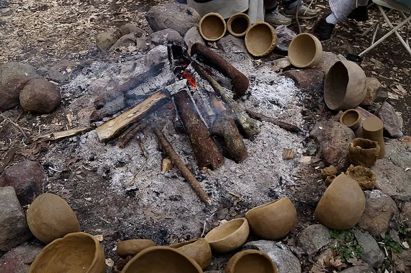 earthen primitive pots drying by an open fire