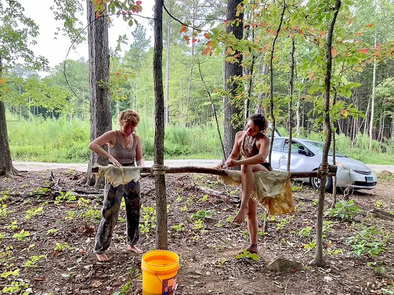 two women tanning and cleaning deer hides