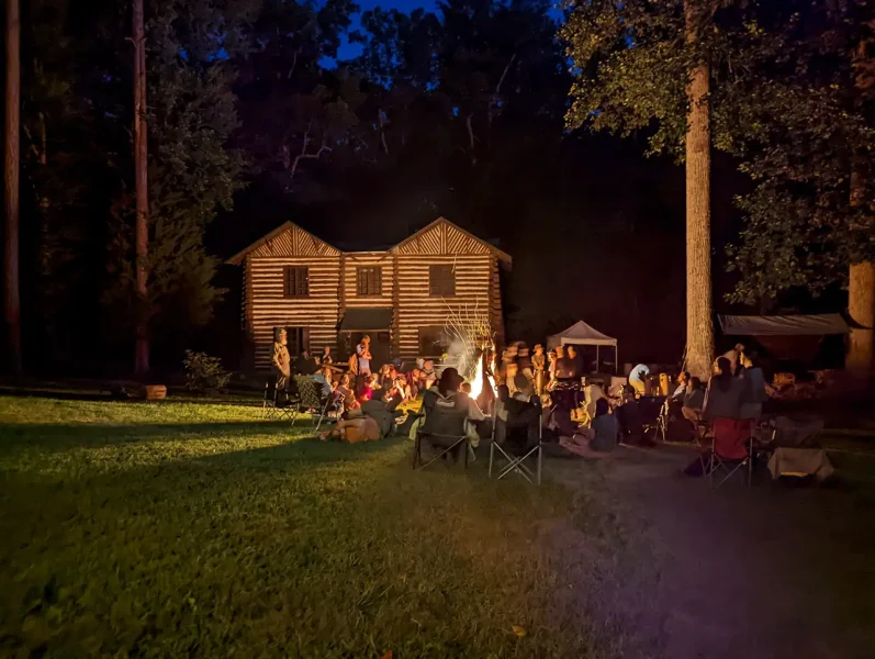 people gathered around a fire in the dark