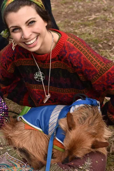 smiling woman sitting with her small dog